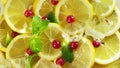 Top view of fresh sliced lemon, mint, berry and ice rotation. Close up. Royalty Free Stock Photo