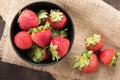 Top view fresh strawberries in a bowl on wooden background. Royalty Free Stock Photo