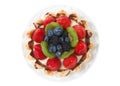 Fresh fruit tart on a plate isolated on white top view