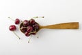 Top view of fresh summer fruits.Wooden spoon and ripe cherries on the white bakcground Royalty Free Stock Photo