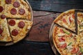 Top view of fresh tasty pizzas on wooden background Royalty Free Stock Photo