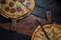 Top view of fresh tasty pizzas on wooden background Royalty Free Stock Photo