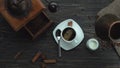 Top view of the fresh turkish coffee poured from copper jezva into the white cup