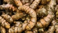 top view of fresh turmeric roots, or curcuma in market. background and texture Royalty Free Stock Photo