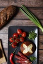 Top view of fresh vegetables with bacon rolls and bread on a kitchen table Royalty Free Stock Photo
