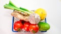 Top view Fresh vegetables in a cart from a supermarket on a white background, natural fresh tomatoes, head of garlic, ginger, cuc Royalty Free Stock Photo