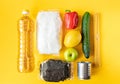 Fresh vegetables, sunflower oil, sugar, pasta, lemon on yellow background