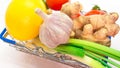 Top view Fresh vegetables in a trolley from a supermarket on a white background, natural fresh food, a head of garlic, ginger Royalty Free Stock Photo