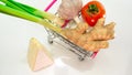 Top view, Fresh vegetables in a trolley on wheels from a supermarket, natural fresh tomatoes and chicken eggs, a head of garlic Royalty Free Stock Photo