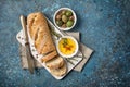 Loaf of bread with spicy olive oil and vintage knife Royalty Free Stock Photo