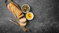 Loaf of bread with spicy olive oil and old rusty table-knife Royalty Free Stock Photo