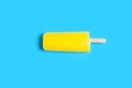 fresh yellow popsicle on blue background