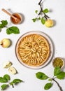 Top view of freshly baked apple pie tart with custard filling and green pistachios. Royalty Free Stock Photo