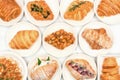 Top view of freshly baked delicious croissants, various types and flavors on white plate, Homemade isolate with white background.