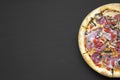 Top view, freshly baked pizza on black background. Flat lay, overhead, from above.