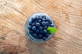 Top view of freshripe blueberries in glass jars on a rustic wood table Royalty Free Stock Photo