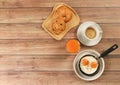 Top view of fried eggs in pan,orange juice , cup of coffee and  danish pastry and Croissant on wooden background Royalty Free Stock Photo