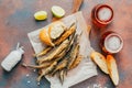 Top view of fried fish, beer, baguette