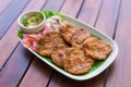 Top view. Fried fish paste balls or deep fried fish cake Contains curry paste as ingredient It is spicy Thai dish served with Royalty Free Stock Photo