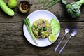 Top view fried rice in a white plate with spoon and fork on old wood table, Broccoli, scallions, melons than lemons are a Royalty Free Stock Photo