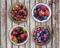 Top view. Fruits and berries in bowl on a wooden background. Ripe raspberries, blueberries, cherries, strawberries, blackberries,