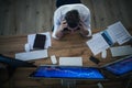 Top view of frustrated businessman with computer working at desk. Financial crisis concept. Royalty Free Stock Photo