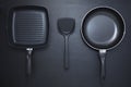 Top view frying pan and plastic spade on black table background. Royalty Free Stock Photo