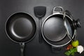 Top view frying pan and pot on black table. Royalty Free Stock Photo