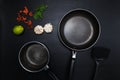 Top view frying pan and pot on black table. Royalty Free Stock Photo