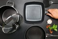 Top view frying pan and pot on black table. Royalty Free Stock Photo