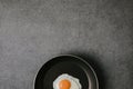 top view of frying pan with tasty fried egg on grey background Royalty Free Stock Photo