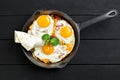 Top view of frying pan with three fried eggs Royalty Free Stock Photo