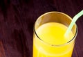 Top of view of full glass of orange juice with straw with space for text Royalty Free Stock Photo