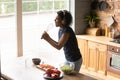 Top view African American woman wearing headphones singing into whisk Royalty Free Stock Photo