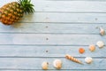 Top view funny Pineapple sea shell wore red sunglasses,sandal and hat on blue wooden background with copy space for summer holiday Royalty Free Stock Photo