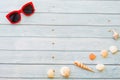 Top view funny Pineapple sea shell wore red sunglasses,sandal and hat on blue wooden background with copy space for summer holiday Royalty Free Stock Photo