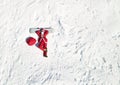 Top view funny santa claus lying on snowboard and wishing merry christmas. Aerial view.