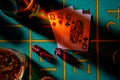 Top view of gaming table in a casino with glasses of whiskey and set of three ladies. Close up of a dark gambling poker