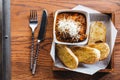 Top view of Garlic bread with meat sauce topping with mozzarella cheese, Served on wooden box with knife and fork Royalty Free Stock Photo