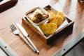 Top view of Garlic bread with meat sauce topping with mozzarella cheese, Served on wooden box with knife and fork Royalty Free Stock Photo