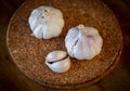 Top view of garlic bulb and cloves on a round cork board Royalty Free Stock Photo