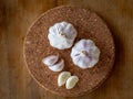 Top view of garlic bulb and cloves on a round cork board Royalty Free Stock Photo