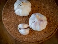 Top view of garlic bulb and cloves on a round cork board Royalty Free Stock Photo