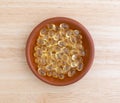 Top view of garlic capsules in a bowl on table