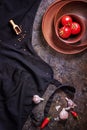 Top view of garlic cloves with red chillies and tomato on stone background with space for text Royalty Free Stock Photo