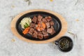 Top view of Garlic Saikoro Steak: medium rare dice wagyu topping with mince carrot on hot plate served with potato salad. Royalty Free Stock Photo