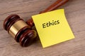 Gavel and adhesive note with text Ethics Royalty Free Stock Photo