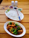 Top view of General Tso's chicken and rice with chopsticks and sauces Royalty Free Stock Photo