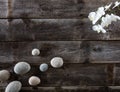 Top view of genuine wood background with pebbles and orchids Royalty Free Stock Photo