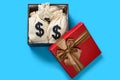 gift box full with US dollar bags on blue background Royalty Free Stock Photo